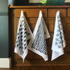 Row of 3 hanging veggie printed tea towels by Betsy Marie