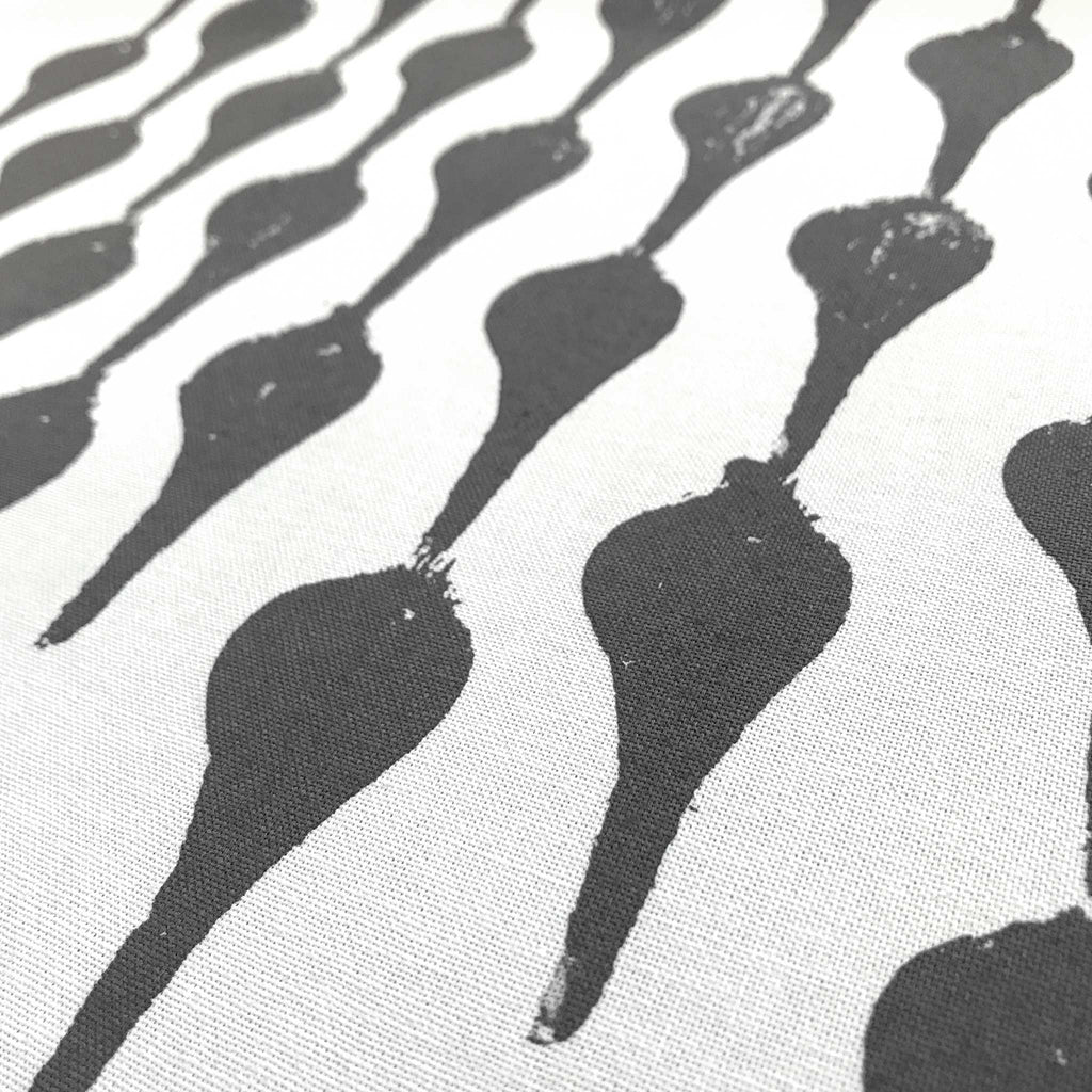Detail of Betsy Marie's veggie printed tea towel with a graphic pattern made from printing beets