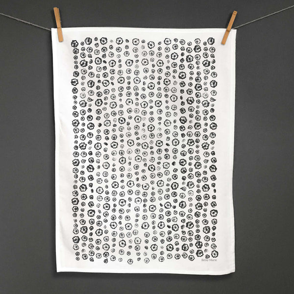 Betsy Marie's veggie printed tea towel with a graphic pattern made from printing okra