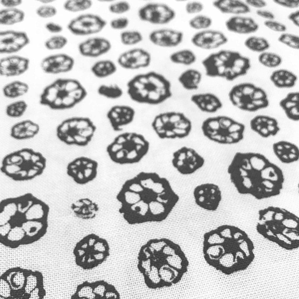 Detail of Betsy Marie's veggie printed tea towel with a graphic pattern made from printing okra